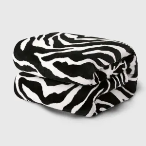 Image détaillée de la Couverture Chauffante Zèbre, motif peau de zèbre noir et blanc, mise en avant de la texture douce et du panneau de contrôle.